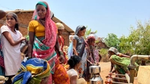 Women filling water carriers at taps