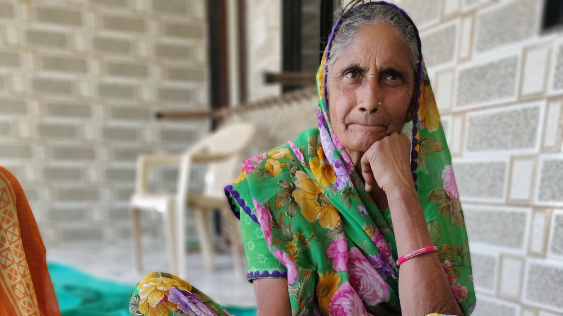 Woman sat outside home