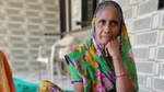 Woman sat outside home