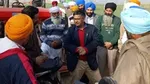 People gathered by a tractor